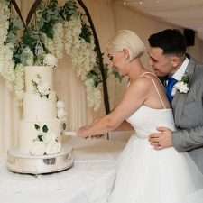 A happy couple cut their wedding cake
